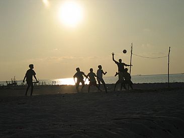 The Volleyball Game - Young boys playing volleyball on their tsunami devastated island in the Maldives by Karen Fischbein
